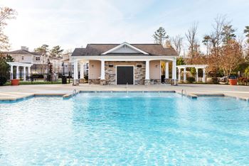 a swimming pool with a house in the background